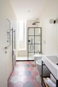 a bathroom with a tub and a toilet and a sink at Comfortable Lux apartments near the Colosseum - Rome in Courmayeur +63 photos