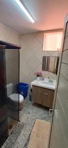 a bathroom with a sink and a toilet and a mirror at Ed Pedro Carneiro in Belém