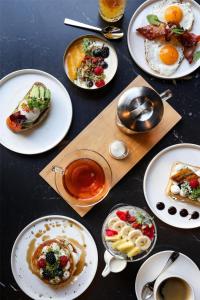 a table topped with plates of food and drinks at Radisson Collection Grand Place Brussels in Brussels