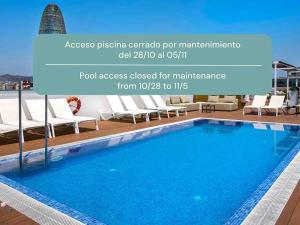 a swimming pool on the roof of a building at Golden Hotel Barcelona in Barcelona