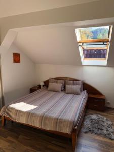 a bedroom with a large bed with a skylight at Villa Zetta in Braşov