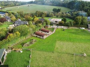 an aerial view of a farm with a large green field at Glamping Pod 1 in Ipplepen