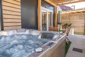 a jacuzzi tub in the backyard of a house at Hiškovec - Holiday Village in Trebnje