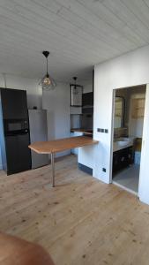 a kitchen with a wooden table in a room at Maison Brunet in Aime La Plagne