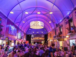 a crowd of people sitting in a room with purple lighting at RiverView Breeze Hamilton 3B2B with Free Parking in Brisbane +34 photos