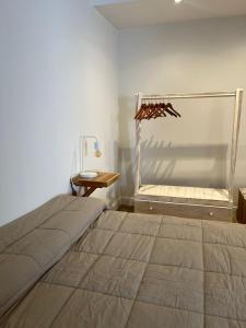 a bedroom with a bed and a wooden table at Andina Apart - Calm in the heart of Mendoza in Mendoza