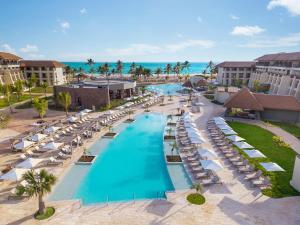 an aerial view of a resort with a pool and chairs at Dreams Playa Esmeralda Resort & Spa - All Inclusive in Miches
