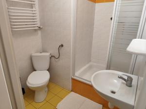 a small bathroom with a toilet and a sink at Dom Studenta nr 2 in Siedlce