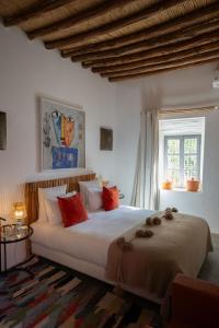 a bedroom with a large white bed with red pillows at Dar Syada Boutique Hotel Marrakech in Marrakech +165 photos