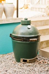 a green pot sitting on the ground next to some stairs at Fernshade Cottage By Birch Stays in Stonehaven