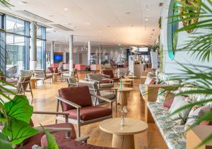 a lobby with couches and chairs and tables at Aquatis Hotel in Lausanne