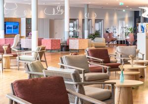 a waiting room with chairs and tables in a store at Aquatis Hotel in Lausanne