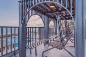a view from the balcony of a resort with a swing at 大武民宿2195 in Shang-wu