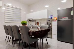 a kitchen with a table and chairs and a refrigerator at 大武民宿2195 in Shang-wu