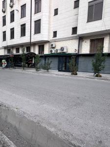 an empty street in front of a building at BEERloga in Samarkand