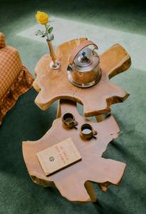 a wooden table with a tea pot on top of it at Hôtel Saint-Georges in Megève +59 photos