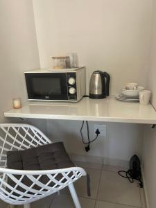 a microwave sitting on top of a counter at Lani Accommodation in Pretoria