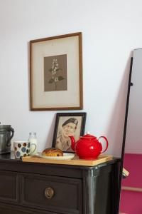 a table with a tea pot and a picture on it at Burnside Cottage By Birch Stays in Stonehaven