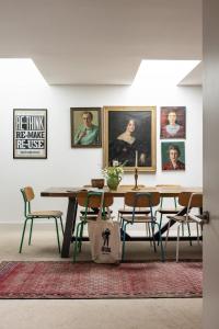 a dining room with a table and some pictures on the wall at Burnside Cottage By Birch Stays in Stonehaven
