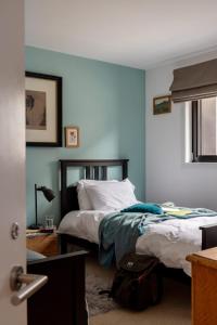 a bedroom with two beds with blue walls at Burnside Cottage By Birch Stays in Stonehaven