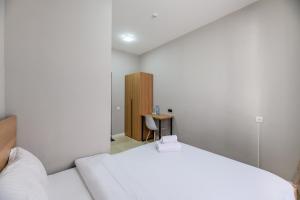 a bedroom with a bed and a small table at Uide hotel in Almaty