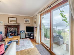 a living room with a view of the ocean at Lochside View in Lochearnhead