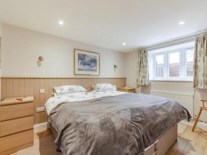 a bedroom with a large bed and a window at The Stables At Wells-In-The-Field Farm in Whitchurch +16 photos