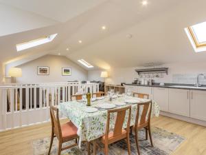 a kitchen and dining room with a table and chairs at The Stables At Wells-In-The-Field Farm in Whitchurch
