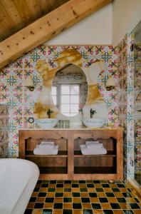 a bathroom with two sinks and a mirror at Hôtel Saint-Georges in Megève