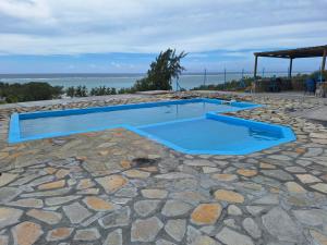 a swimming pool on top of a stone patio at Belle étoile Gravier île Rodrigue in Saint Francois