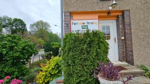 a sign for a fertility clinic in front of a building at Ferienwohnung Stephan in Berggiesshübel