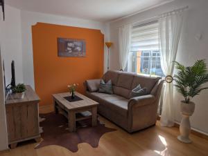 a living room with a couch and a table at Ferienwohnung Stephan in Berggiesshübel