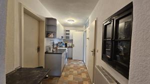 a kitchen with white cabinets and a counter top at Ferienwohnung Stephan in Berggiesshübel