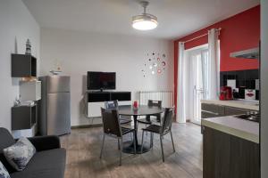 a kitchen with a table and chairs in a room at IoEma b&b in Porto SantʼElpidio