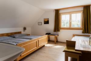 a bedroom with two beds and a sink and a tub at Gasthaus Moosegg in Lochau +13 photos