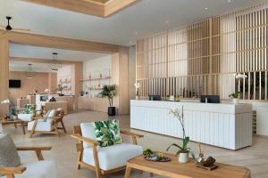 a lobby with a waiting area with chairs and tables at Dreams Playa Esmeralda Resort & Spa - All Inclusive in Miches