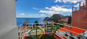 a balcony with two tennis rackets on a balcony at HOSTAL PIEDRA ANDINA - Copacabana in Copacabana