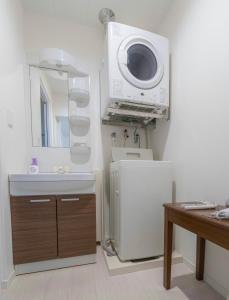 a bathroom with a sink and a microwave at 沖縄SunSea海景酒店整套公寓 那霸机场20分钟车程 