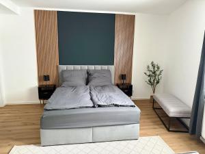 a bedroom with a bed and a chair in it at Modern Holiday Apartment in Osnabrück 13001 in Osnabrück