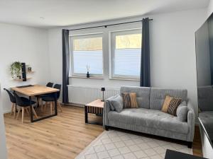 a living room with a couch and a table at Modern Holiday Apartment in Osnabrück 13001 in Osnabrück +5 photos