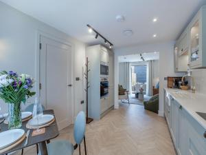 a kitchen and living room with a table and chairs at Sea Beet - Uk49245 in Whitstable