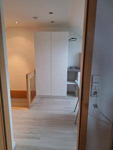 a hallway with a white closet and a staircase at Haus Frank in Wehr +3 photos