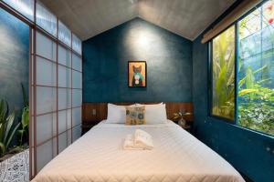 a bed in a room with blue walls and windows at AN Village 1 in Vung Tau +72 photos