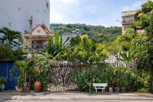 a fence with flowers and plants in front of a building at AN Village 1 in Vung Tau