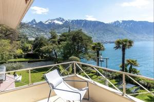 a balcony with a view of the water and mountains at La Villa in Montreux +53 photos