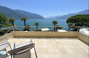 a balcony with chairs and a view of the water at La Villa in Montreux