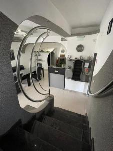 a spiral staircase leading to a kitchen and a living room at Pensiunea Carina in Bran