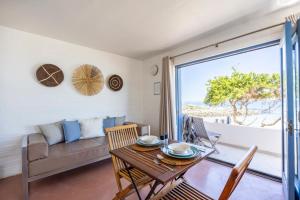 a living room with a couch and a table at Seehuis Studios in Langebaan +13 photos