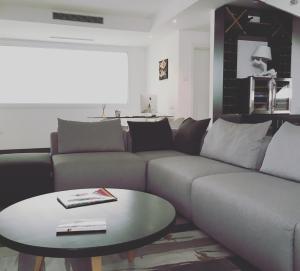 a living room with a couch and a table at Residenza RoMa in Tropea