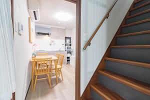 a small kitchen and dining room with a table and chairs at 頤和小屋 in Osaka